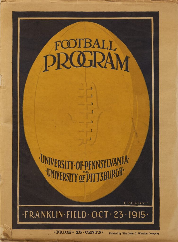 Vintage black and gold program cover with a large football depicted and verbiage of 1915 Penn versus Pitt football program cover E. Gilbert was the Illustrator