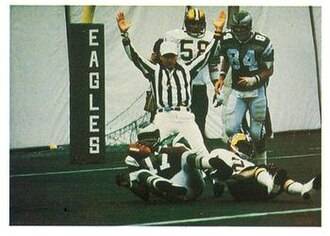 Full Color Carmichael scoring a touchdown with the Eagles in 1977. Jeno's - "1986 Jeno's Pizza - #6 Harold Carmichael". Jeno's. 1986. football card from the 1986 Jeno's Pizza NFL football card stickers set of Philadelphia Eagles wide receiver Harold Carmichael scoring a touchdown against the New Orleans Saints during a November 6, 1977 home game at Veterans Stadium. The card is numbered #6 in the set. The back of the card reads: THIS IS A FAMILIAR SIGHT Eagles wide receiver Harold Carmichael lands in the New Orleans Saints' end zone with one of the 79 touchdown passes he caught in his 14-year NFL career. The Philadelphia star also caught passes in 127 consecutive games to establish an NFL record, surpassing the old mark of 105 in 1979.