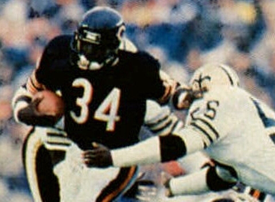 Color image of Chicago Bears' running back Walter Payton rushing the ball against the New Orleans Saints on October 7, 1984, breaking the NFL's all-time rushing record.