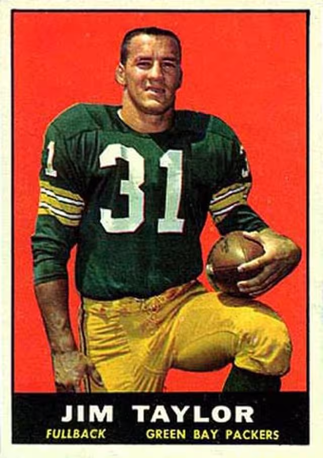 football card image of Green Bay Packer Jim Taylor kneeling in uniform holding a football