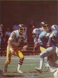 Full color game action of Sims (with ball) against the San Diego Chargers in 1981.