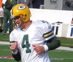 Full color image of Brett Favre in a white Green Bay Packers number 4 uniform. Favre in 2006 Photo taken and uploaded by PSUMark2006 at en.wikipedia - Originally from en.wikipedia; description page is/was here Green Bay Packers quarterback Brett Favre during on-field warmups at Ralph B. Wilson Stadium in Orchard Park, New York, prior to a game against the Buffalo Bills on November 5, 2006.
