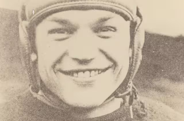 Vintage, yellowed, b/w image of Chic Harley in leather helmet and Ohio State football uniform, smiling.