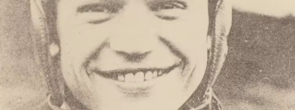 Vintage, yellowed, b/w image of Chic Harley in leather helmet and Ohio State football uniform, smiling.