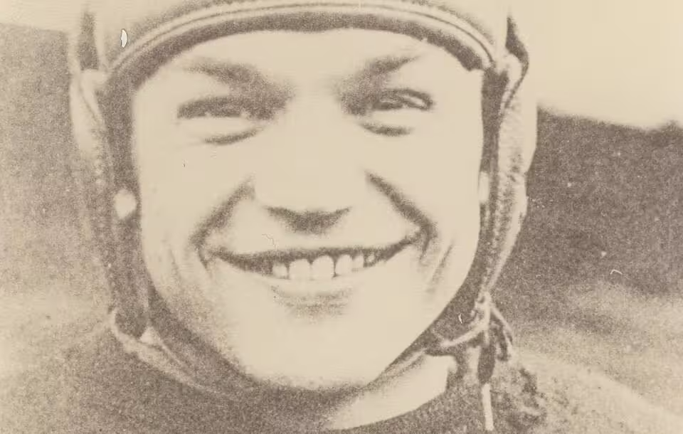 Vintage, yellowed, b/w image of Chic Harley in leather helmet and Ohio State football uniform, smiling.