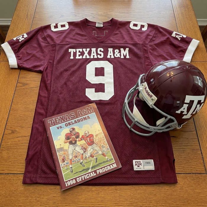 Gemini AI-created image of a 1998-era Texas A&M American football jersey 9, without a name on it, and a matching period-correct helmet, the program cover appropriate to the era and team.