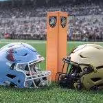 Color photo of a Deleaware Stae and an Army helmet in front of an orange pylon.
