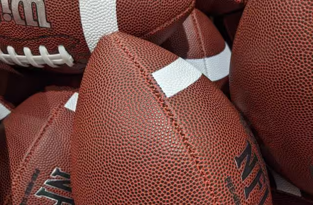 Image of many NFL Wilson Footballs in a Barrell, taken by Darin Hayes' 2021.