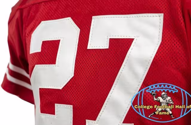 Canva AI-created of a red Ohio State jersey from the Era of Eddie George, number 27 with a Pigskin Dispatch College Football HOF seal.