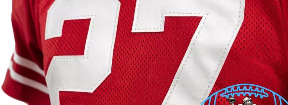 Canva AI-created of a red Ohio State jersey from the Era of Eddie George, number 27 with a Pigskin Dispatch College Football HOF seal.
