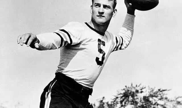 b/w promotional publicity phot of Checiag Bear's player George McAfee posing in a throwning the football motion wearing his white number 5 Bears jersey without a helmet