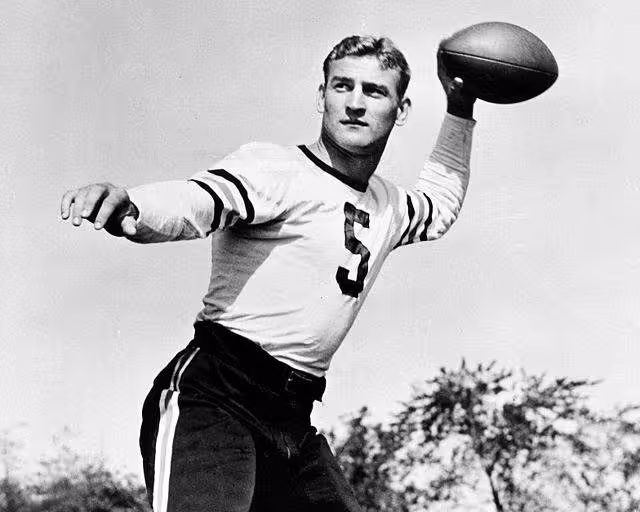 b/w promotional publicity phot of Checiag Bear's player George McAfee posing in a throwning the football motion wearing his white number 5 Bears jersey without a helmet