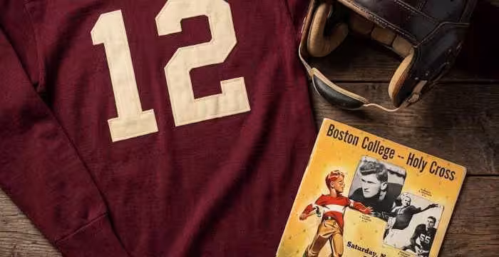 Gemini AI-created image of a 1942-era Boston College American football jersey 12, without a name on it, and a matching period-correct helmet, the program cover appropriate to the era and team.