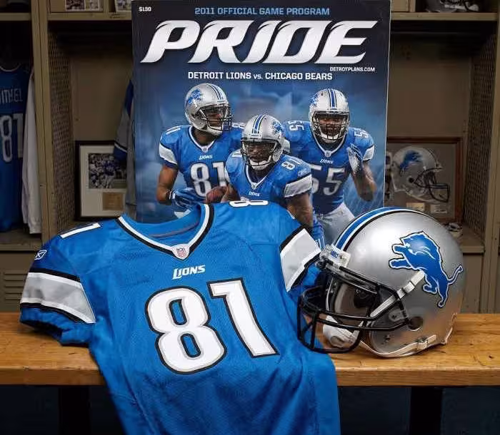 Gemini AI-created image of a 2011-era Detroit NFL American football jersey 81, without a name on it, and a matching period-correct helmet, the program cover appropriate to the era and team.