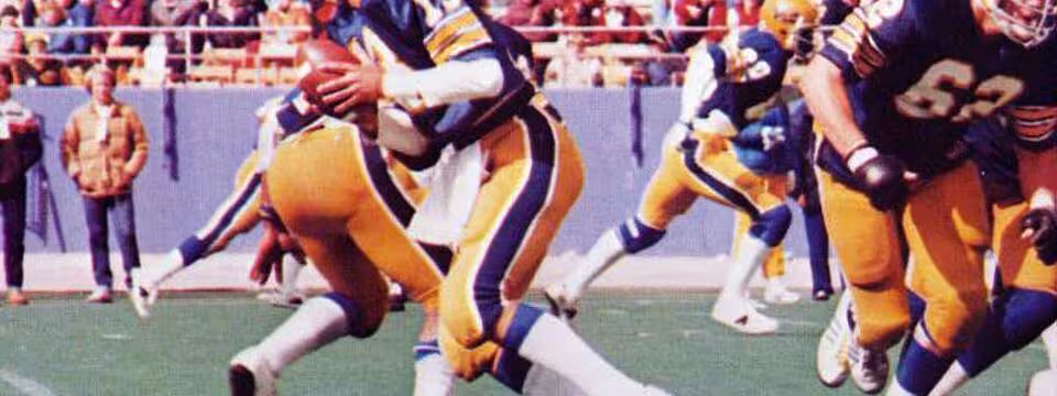 Full color game day action photo of Dan Marino quarterbacks the Pitt Panthers of the University of Pittsburgh in a football game at Pitt Stadium against the Cincinnati Bearcats on October 13, 1979. Pitt won the game 35-0.