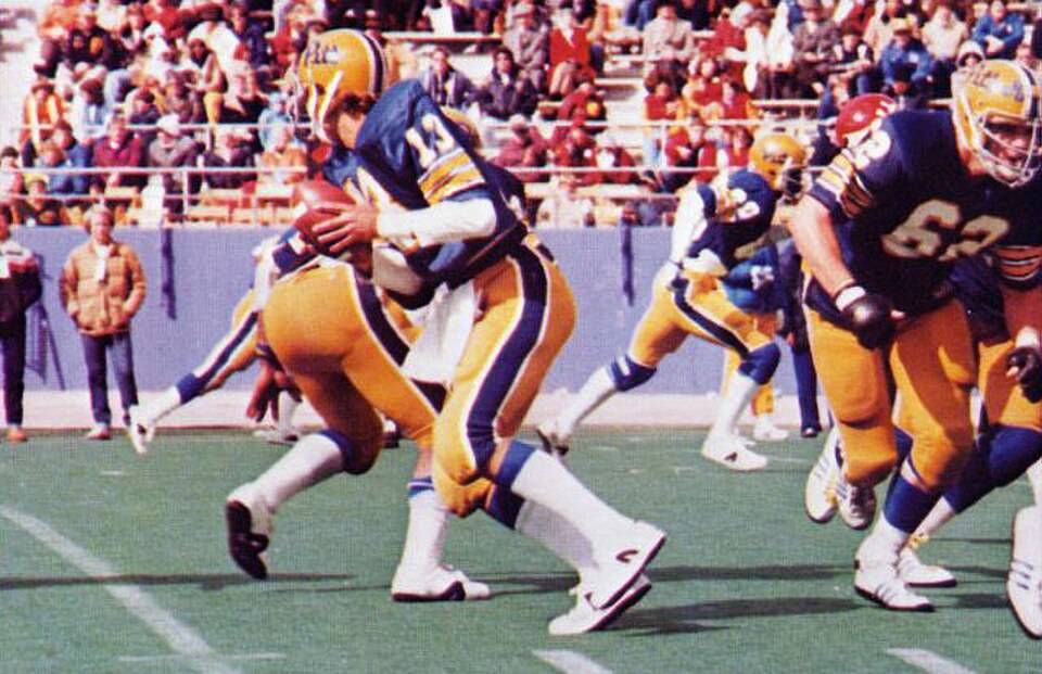 Full color game day action photo of Dan Marino quarterbacks the Pitt Panthers of the University of Pittsburgh in a football game at Pitt Stadium against the Cincinnati Bearcats on October 13, 1979. Pitt won the game 35-0.