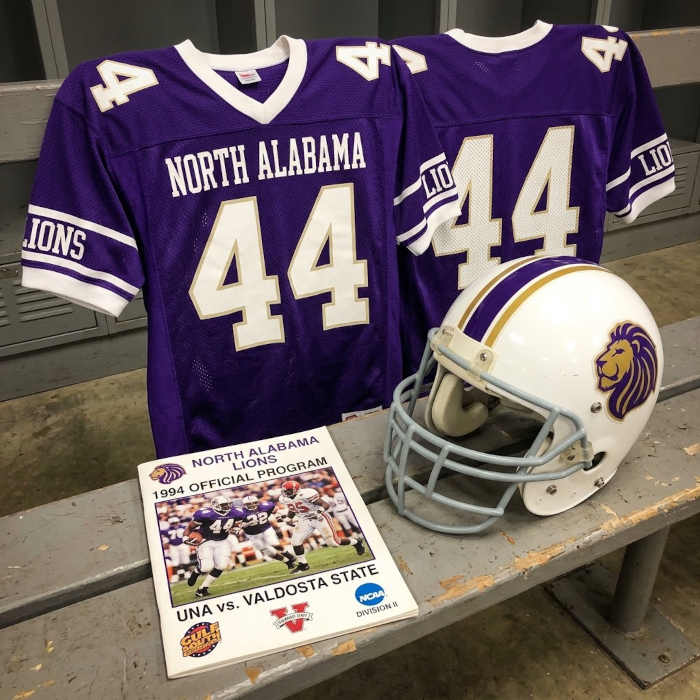 Gemini AI-created image of a 1994-era North Alabama American football jersey 44, without a name on it, and a matching period-correct helmet, the program cover appropriate to the era and team.