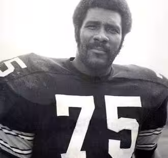 B/W image of Joe Greene #75 with Steelers in 1975.