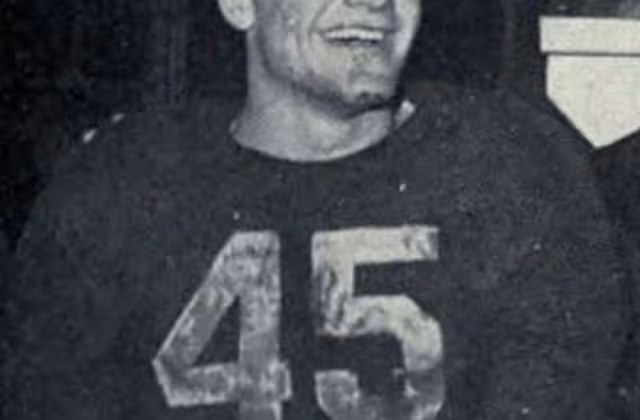 Black and white image of Photograph of Pete Elliott wearing his dark UM #45 jersey, celebrating Michigan's 1947 Big Nine championship.