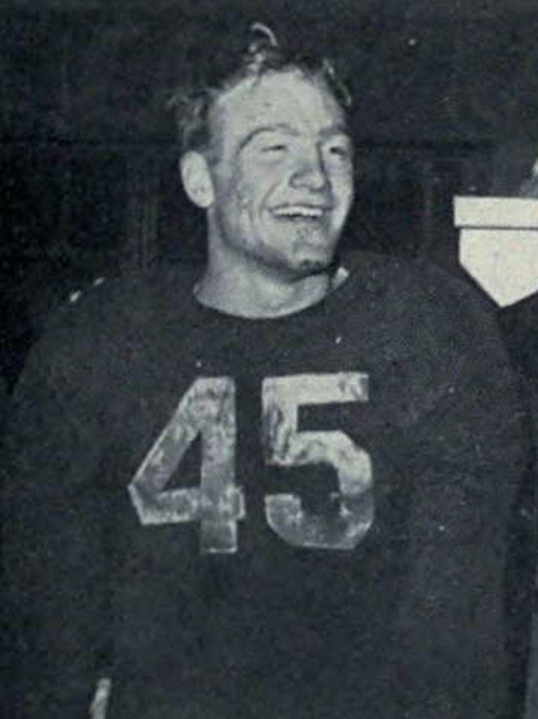 Black and white image of Photograph of Pete Elliott wearing his dark UM #45 jersey, celebrating Michigan's 1947 Big Nine championship.