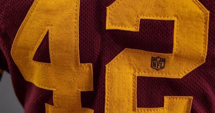 Dark red American football jersey with yellow "42" on it