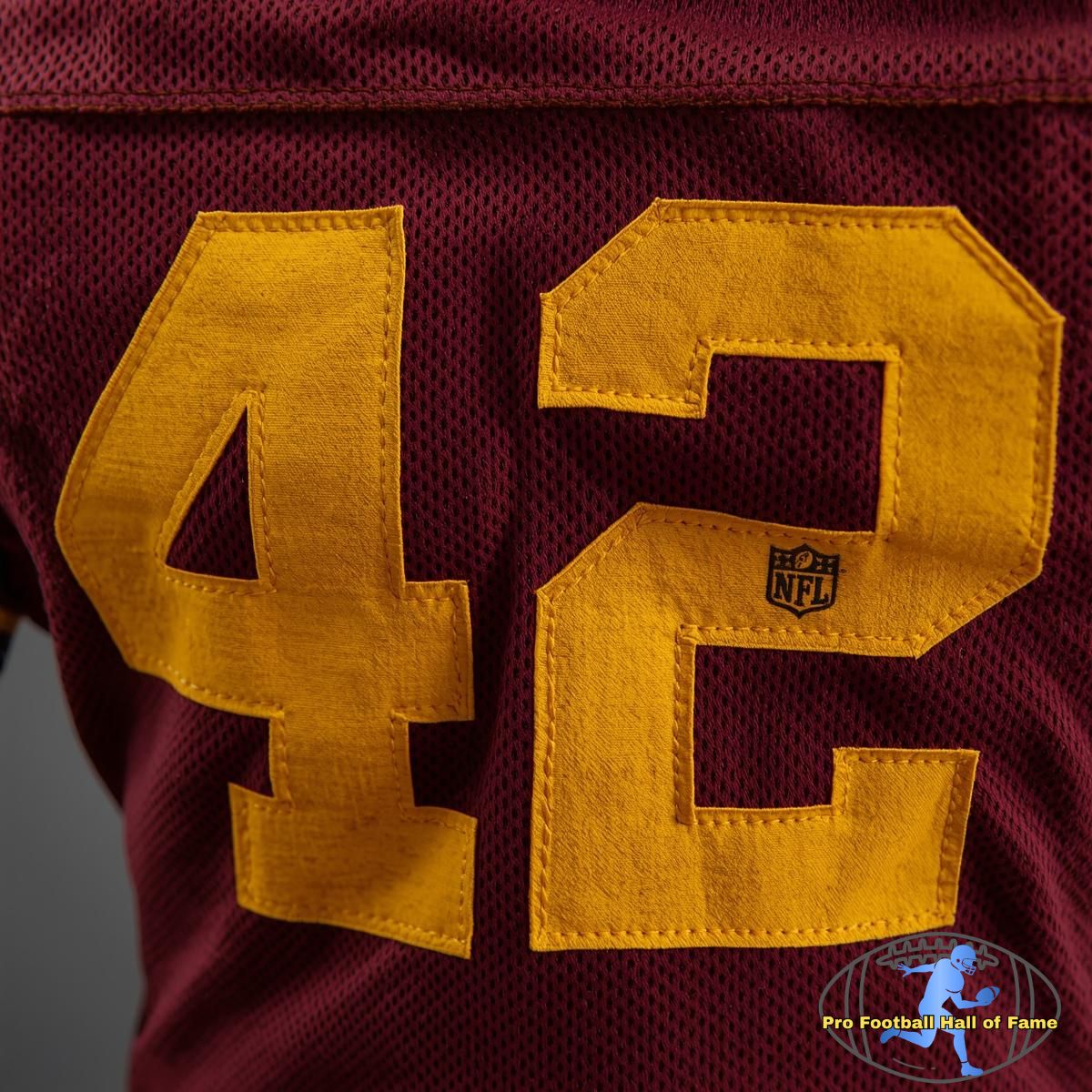 Dark red American football jersey with yellow "42" on it
