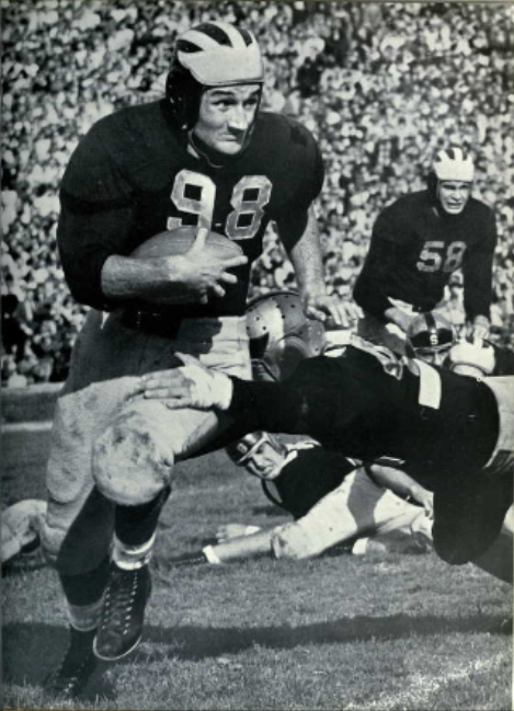 Vintage b/w photo game action of Photograph of University of Michigan player #98 Tom Harmon from 1941 Michiganensian via a kind uploader to Wikimedia Commons who shared it.