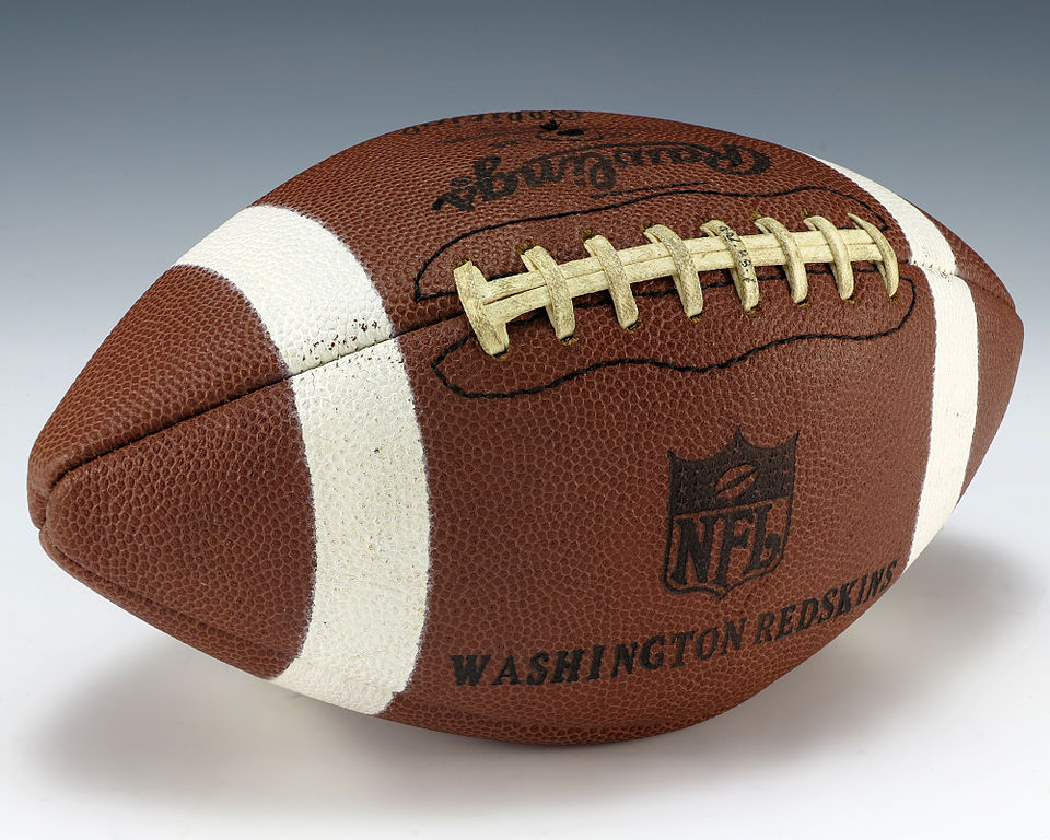 Color image of a white striped football that says NFL Washington Redskins