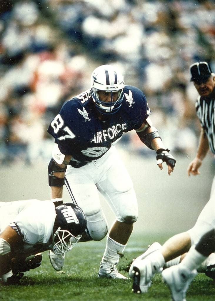 Full color game day action shot of Former Air Force great Chad Hennings, a 1988 graduate of the Air Force Academy, was elected to the College Football Hall of Fame on May 16, 2006. He was considered one of college football's great defensive linemen of his era, a unanimous first-team All-America selection in 1987 who received the Outland Trophy as the nation's top interior lineman. As a pro, he embarked on a nine-year NFL career with the Dallas Cowboys that brought him three Super Bowl titles. (U.S. Air Force photo).