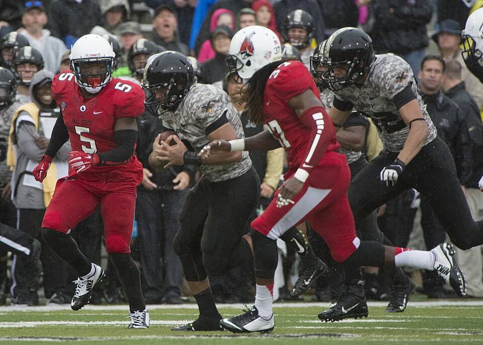 full color game action shot in 2014, A football game between Army and Ball State in 2014. Taken by John Pellino via Wikimedia Commons.