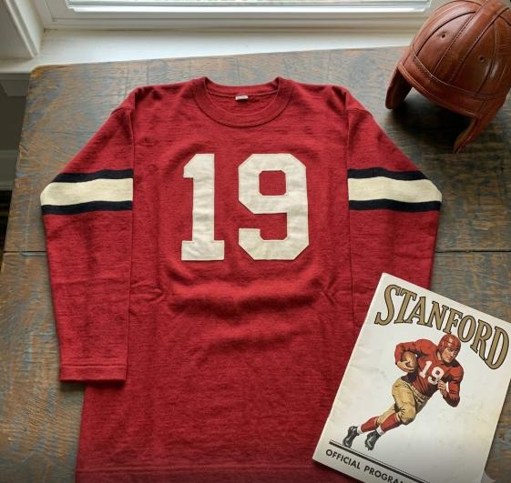 Vintage Stanford #19 football jersey. Red mesh with white and black shadowed block numbers and triple-striped sleeves.