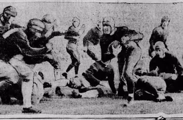 Vintage b/w newspaper image of Harry Stuhldreher carries ball against Stanford in Rose Bowl, Jan. 1, 1925.jpg Caption text says "Harry Stuhldreher, Notre Dame quarterback and all-American in the position on most of the team picked by the critics, is shown here carrying the ball in the New Year's day game between Notre Dame and Stanford in the Rose bowl at Pasadena, Cal. Evidently he did not gallop far as his foot slipped out of bounds as the photo was snapped and as three husky Cardinals (at the left) charged him. Apparently it was an out-of-bounds play by Notre Dame, so that the latter could get the ball fifteen yards from the sideline." The Des Moines Register
