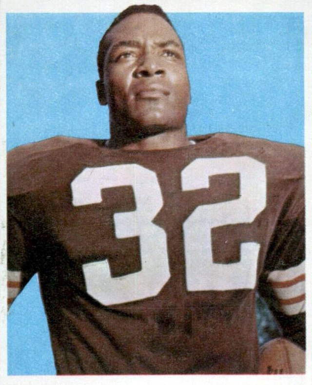 Vintage publicity shot of Jim Brown in 1959 wearing his Cleveland Browns number 32 jersey with helmet off.