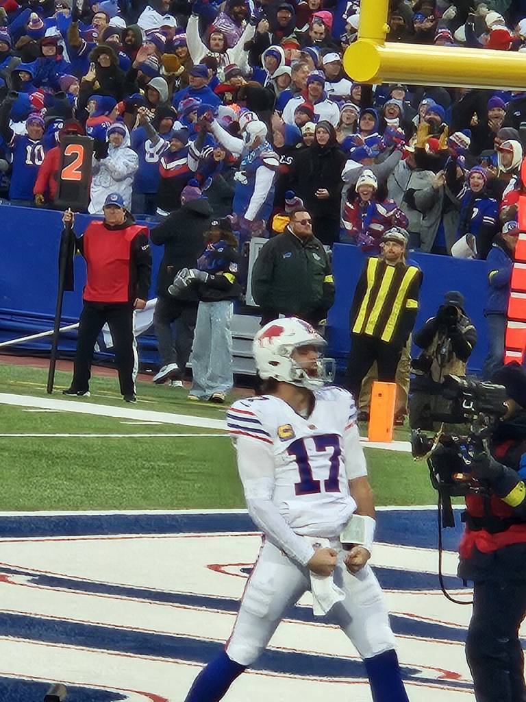 Full color, Bills QB Josh Allen celebrates his sixth TD of the day as the CBS cameraman videotapes. Image courtesy of Wikimedia Commons contributor, WuTang94.