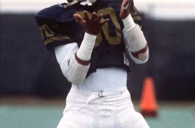 US Naval Academy Midshipman First Class Napoleon "Nap" McCallum practices with a coach. An All-American football player and a sixth-place finisher in the 1983 Heisman Trophy contest, McCallum holds 16 Naval Academy football records. Location: Annapolis, Maryland