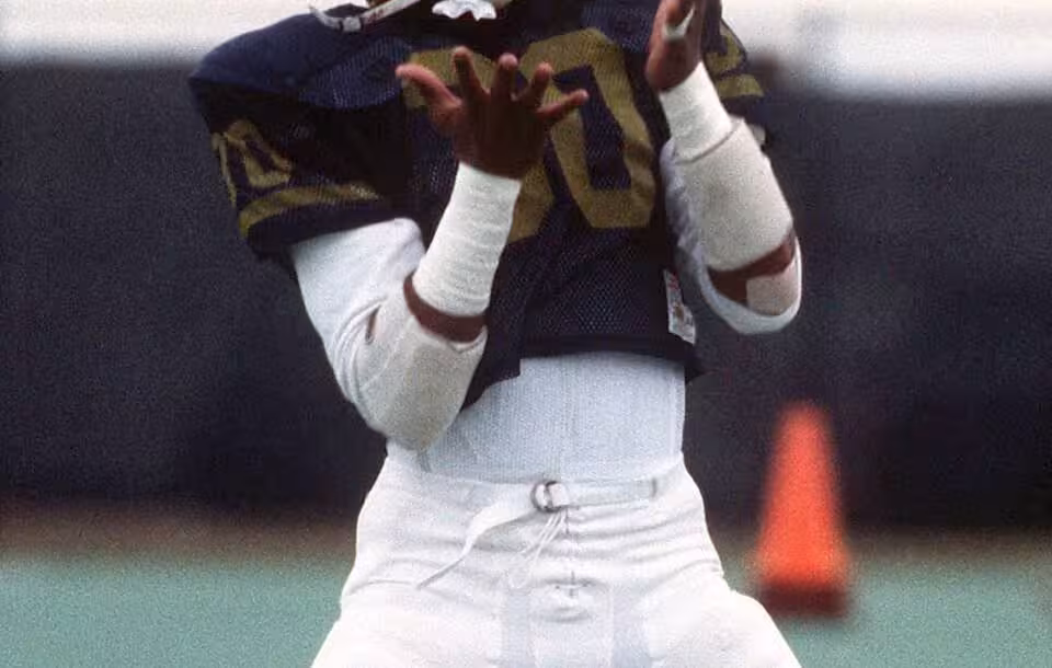 US Naval Academy Midshipman First Class Napoleon "Nap" McCallum practices with a coach. An All-American football player and a sixth-place finisher in the 1983 Heisman Trophy contest, McCallum holds 16 Naval Academy football records. Location: Annapolis, Maryland