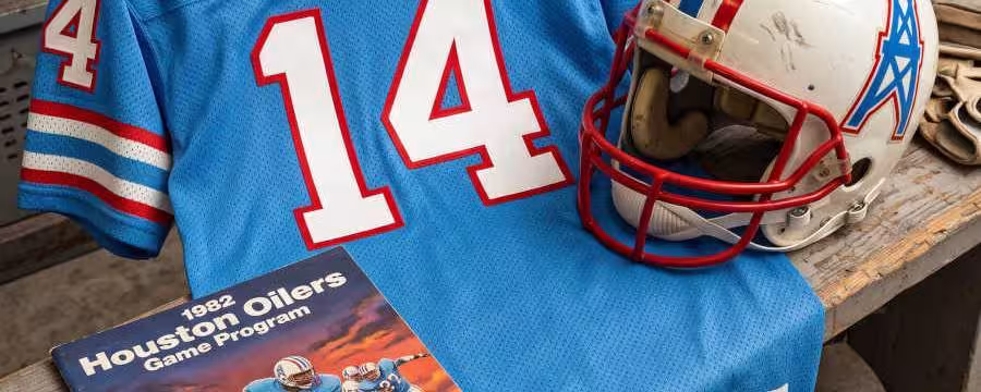 Gemini AI-created image of a 1982-era Houston Oilers American football jersey 14 jersey, without a name on it, and a matching period-correct helmet, the program cover appropriate to the era and team.