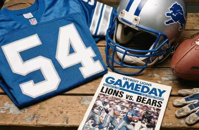 Gemini AI-created image of a 1990-era Detroit NFL American football jersey 54, without a name on it, and a matching period-correct helmet, the program cover appropriate to the era and team.