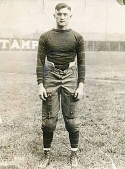 Vintage, B/W full body publicity pose of Tom Davies in 1921, in full Pitt football uniform.