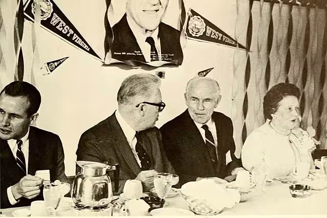 b/w phot publicity shot of Rooney (second from left) during a luncheon at West Virginia University in 1962 via West Virginia University