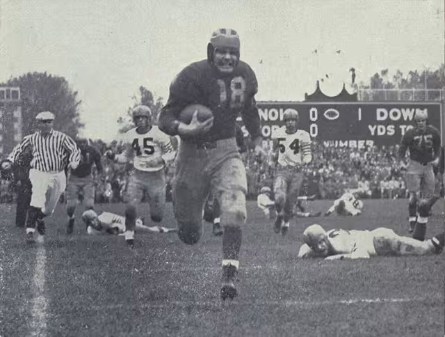 black and white game action image of Bump Elliott on a 74 yard touchdown run for Michigan's first touchdown against Illinois in 1947