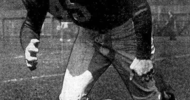 b/w newspaper image of an action shot publicity photo of American football player Chuck Taylor in 1942