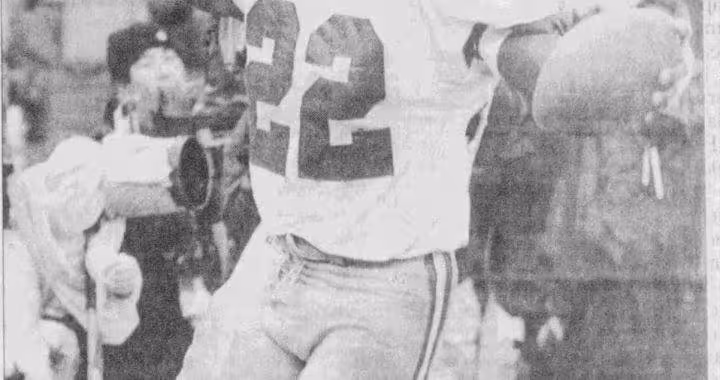 A black-and-white AP Photo clipping of Dallas Cowboys running back Emmitt Smith (#22) celebrating a touchdown. He is shown with his arms outstretched, holding the football in his left hand, after a play at Candlestick Park. The caption reads: 'Dallas' Emmitt Smith had little trouble with the field at Candlestick, rushing for 114 yards and catching a key 16-yard touchdown pass from Troy Aikman.