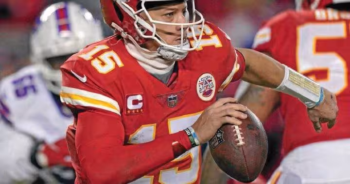 color game action image of Patrick Mahomes of the Chiefs with ball in hand looking for a passing lane