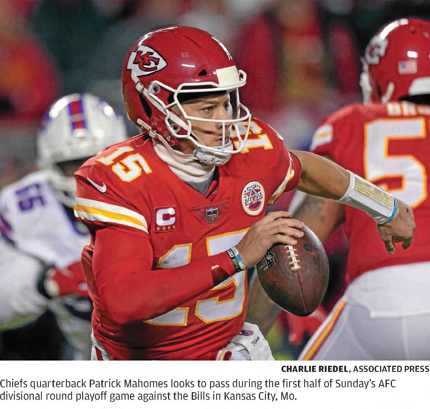 color game action image of Patrick Mahomes of the Chiefs with ball in hand looking for a passing lane
