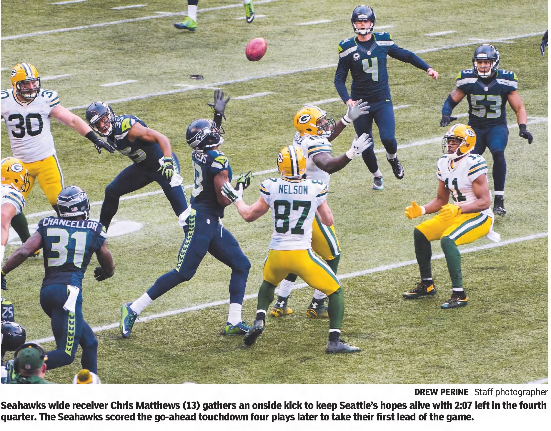 color newspaper image of game action and a tipped pass in the Seattle vs Green Bay Monday, January 18, 2015