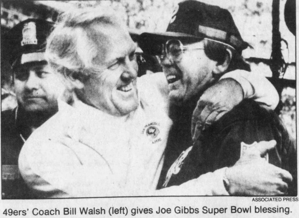 black and white news paper Image of Bill Walsh congratulating Joe Gibbs