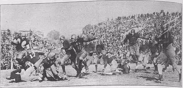 black and white A scene from the November 14, 1925 football game between the Georgia Bulldogs and the Georgia Tech Golden Tornado at Grant Field in Atlanta. The caption reads: "Wycoff fails to go around end."