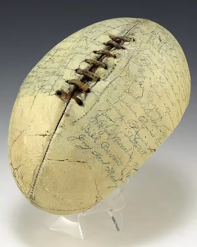 image of a white leather hide football with rawhide lacing was autographed by the members of the 1935 Collegiate All-Star Team, including Gerald R. Ford.