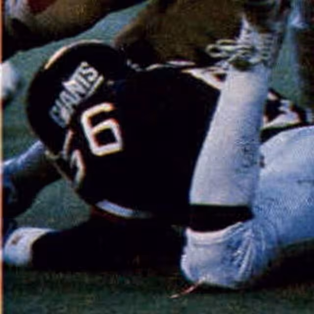 New York Giants linebacker Lawrence Taylor in his blue number 56 jersey pictured in a defensive play against the San Francisco 49ers